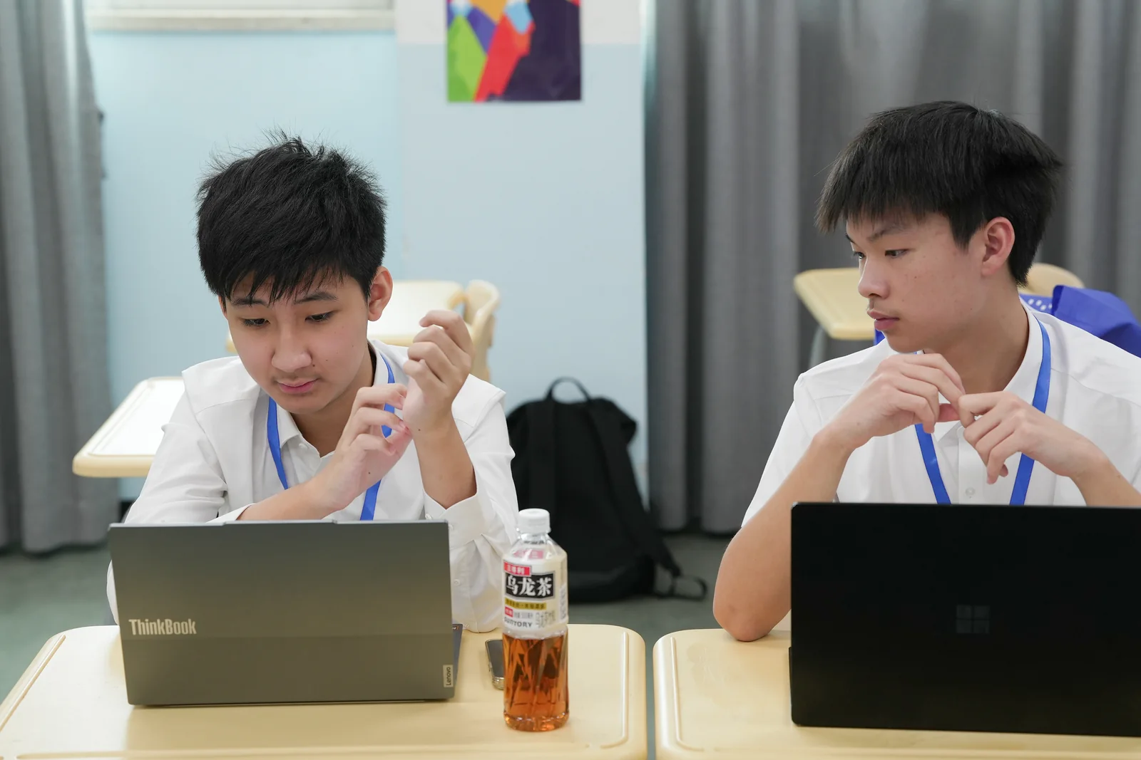 Jacky Huang preparing at a laptop during a debate tournament.