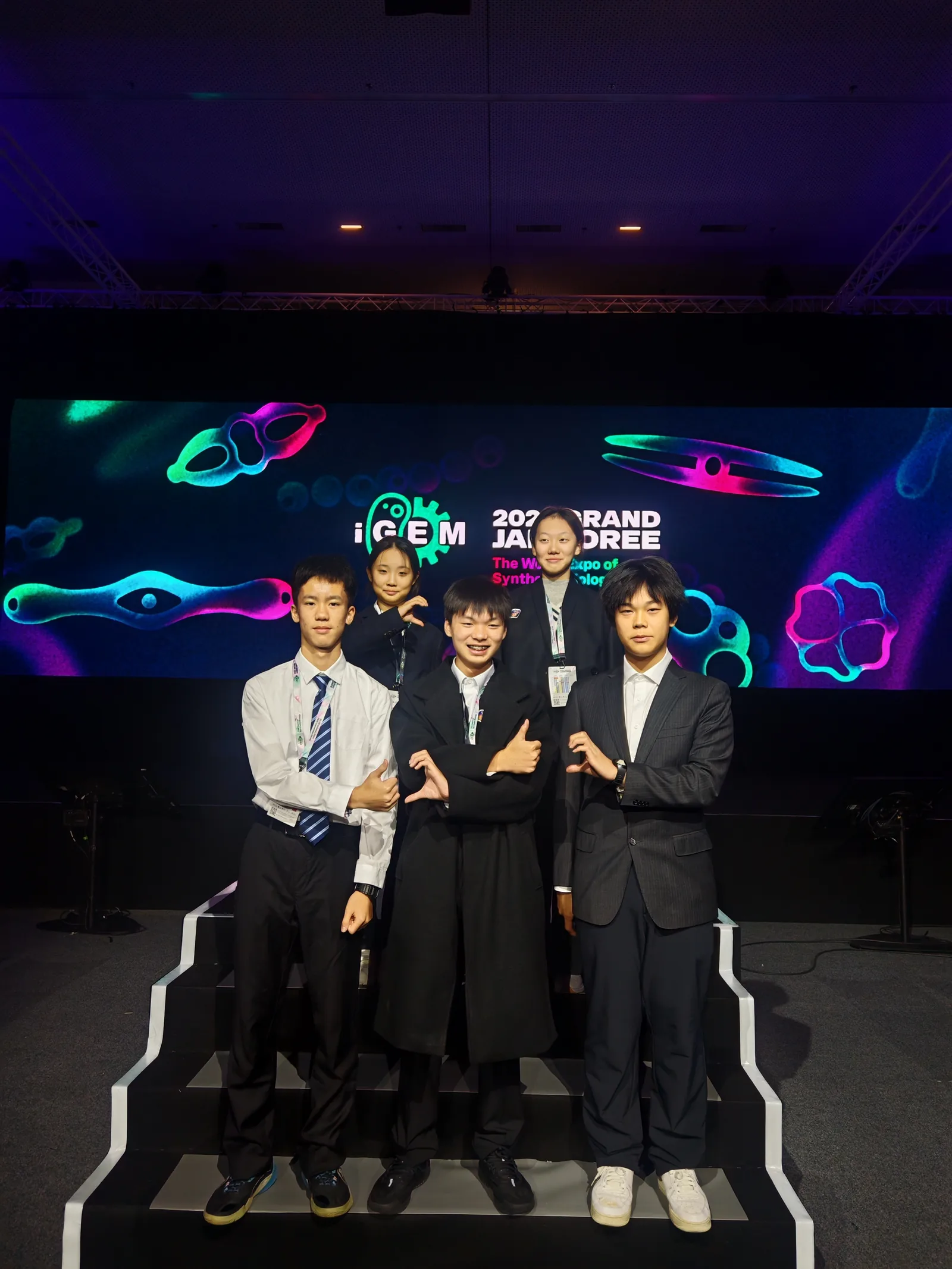 The team presenting on stage at the iGEM Grand Jamboree.