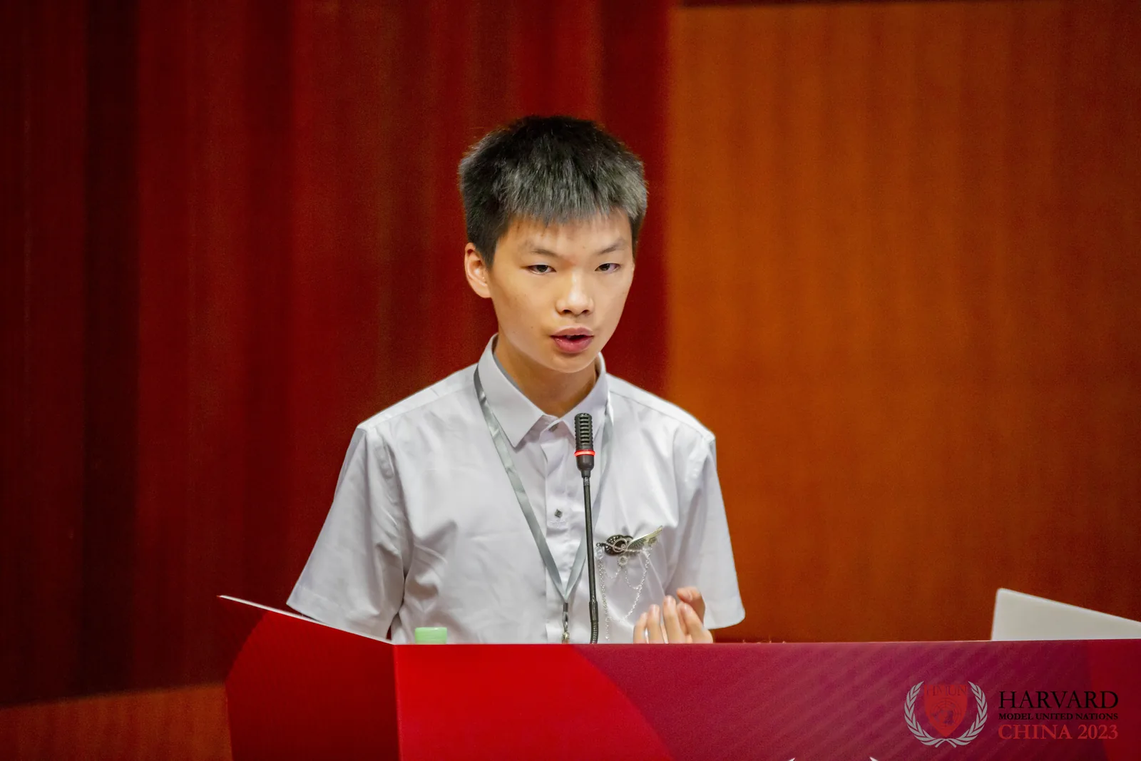 Jacky speaking at a Model United Nations podium.
